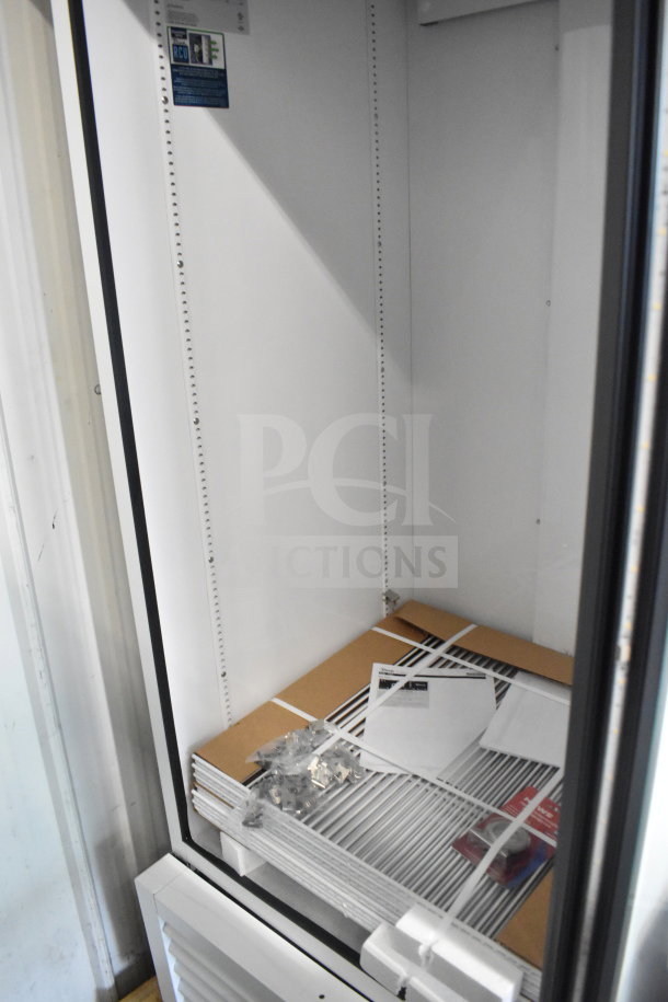 Brand new True TSCI-600R-G-PH commercial single door cooler, 115 Volts, scratch and dent condition, with shelves and manual inside.