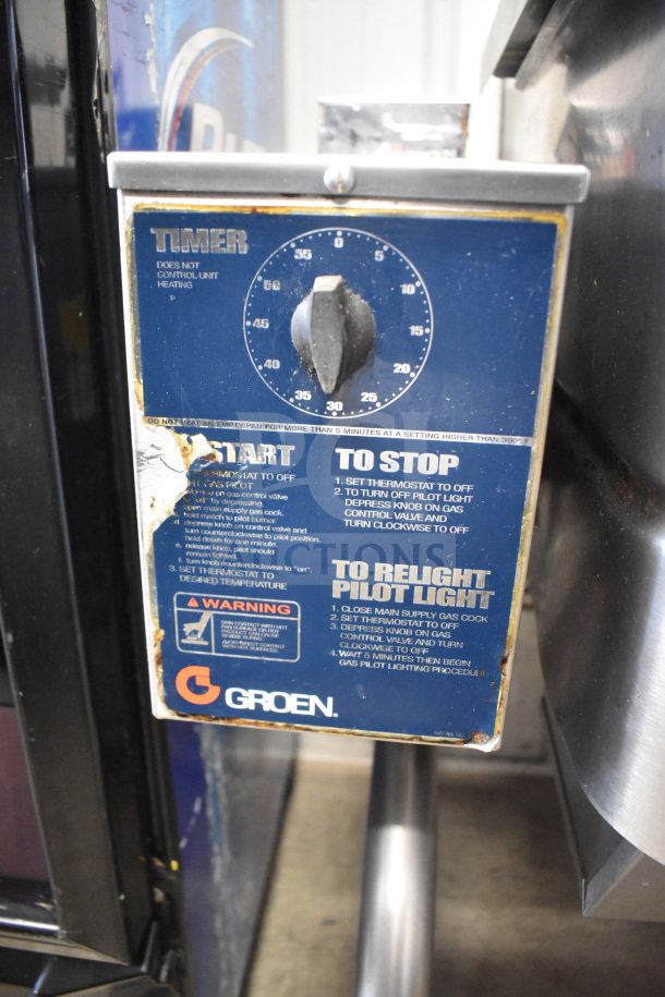Groen commercial floor style braising pan, natural gas powered, 104,000 BTU, visible timer and operational instructions on panel.