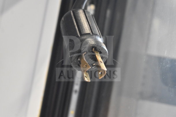Close-up of a power plug for the 2017 True GDM-72F-HC commercial 3 door reach-in freezer merchandiser.