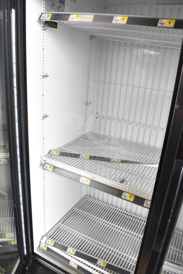 2017 True GDM-72F-HC commercial 3-door freezer merchandiser, tested and working. Features wire shelves, visible tags.