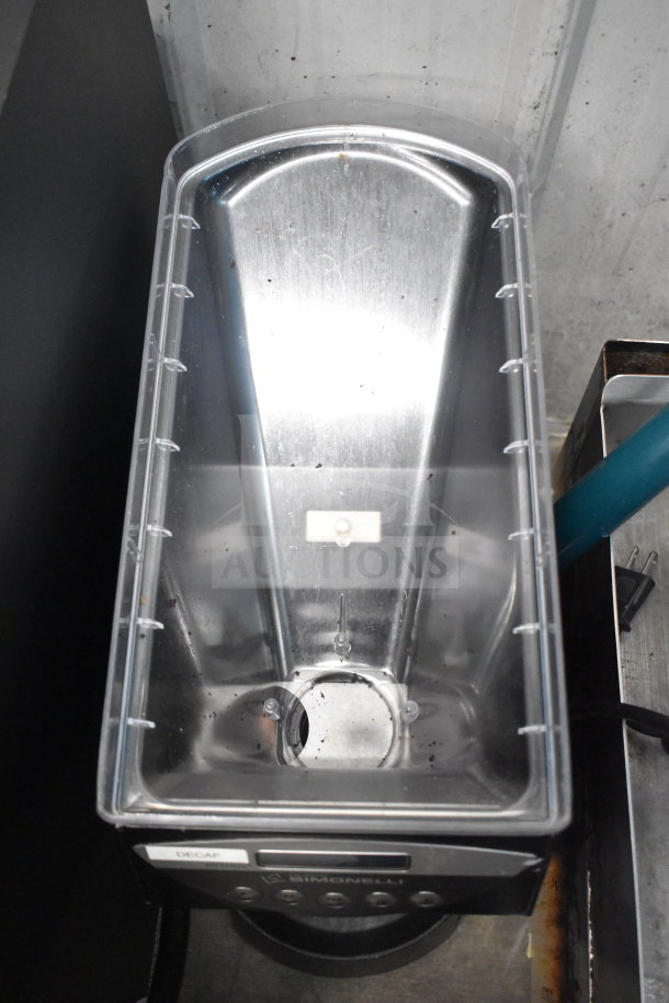 Nuova Simonelli Mythos One Clima Pro espresso grinder, 115V, visible "Decaf" label, stainless steel chamber.