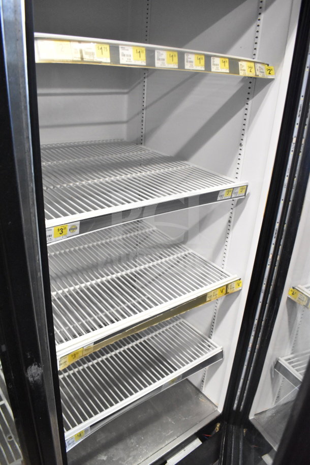 2017 True GDM-72-HC commercial 3-door reach-in cooler, white interior, metal shelves, price tags visible, tested working.