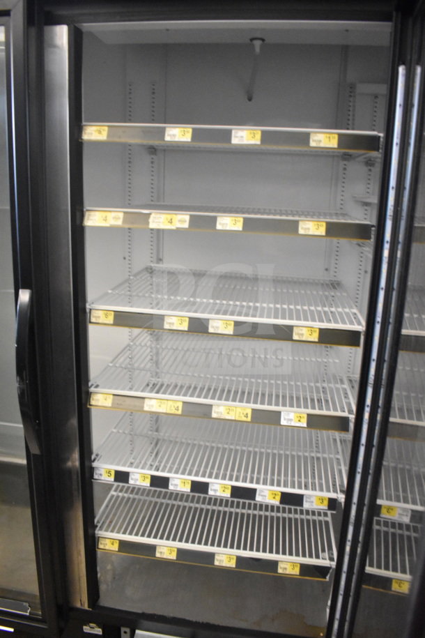 2017 True GDM-72-HC 3-door cooler merchandiser, tested, working, 115V, 1-phase. Clean shelves, clear glass, price labels visible.