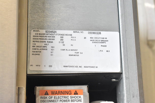 Manitowoc SD0452A Commercial Ice Maker and SPA310 Dispenser with label showing model and specs. 115V, 1 Phase, R404A refrigerant.