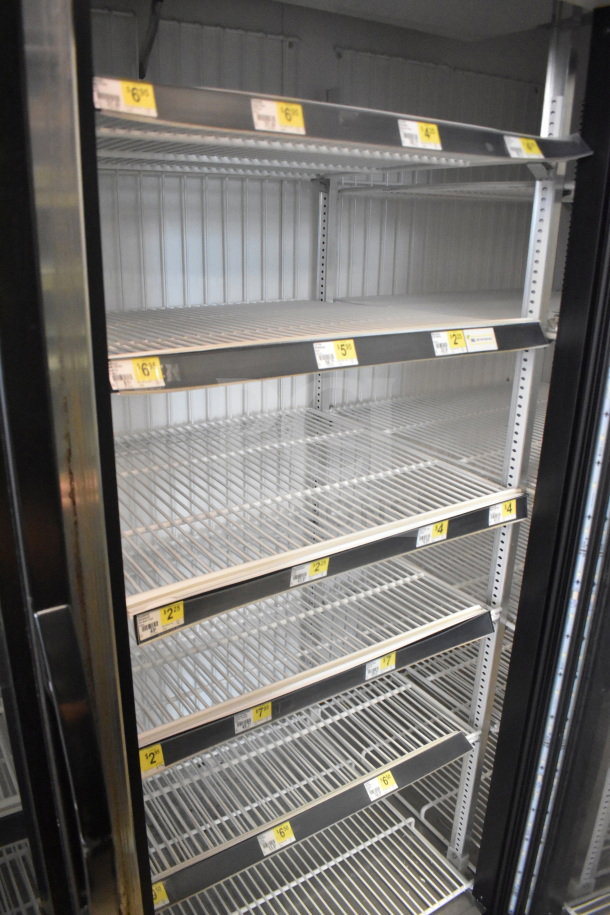 2017 True GDM-72F-HC commercial 3-door freezer with adjustable wire shelves, black exterior, and power specs. Tested, working.