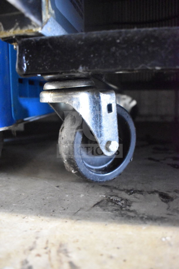 2019 True T-49F-HC commercial cooler caster wheel close-up. Sturdy, showing functionality and stability for smooth movement.