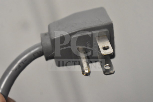 Close-up of a gray plug for the AHT RIO S 100 Commercial Chest Freezer, 115 Volts, 1 Phase.
