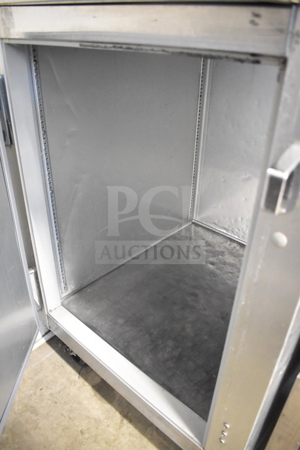 2021 True STG1F-2HSLH-HC commercial cooler, 2 half doors, commercial casters, 115V, 1 phase, interior view, excellent condition.