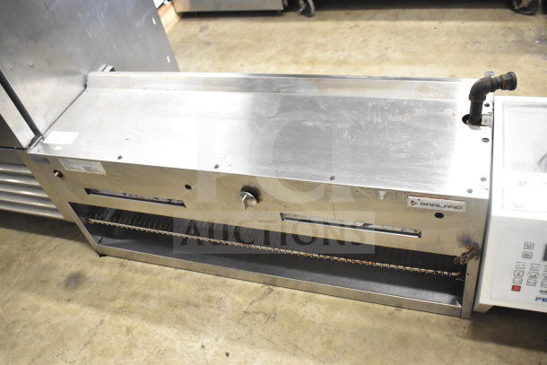 Garland commercial gas cheese melter, stainless steel, used, visible Garland logo, adjustable heat settings.