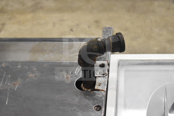 Garland Commercial Gas Powered Cheese Melter with visible rust and wear on metallic surface and pipe connection.