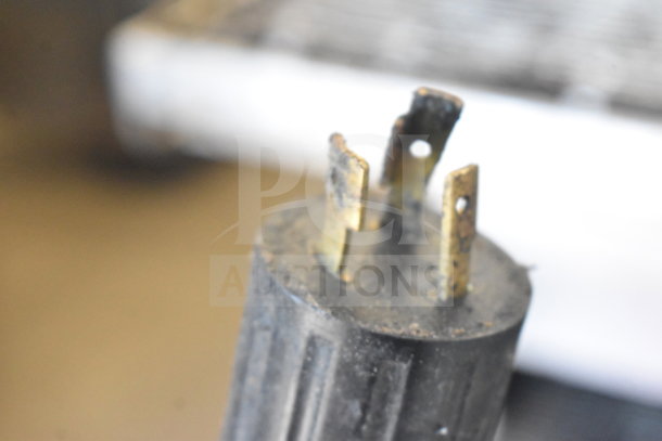 Close-up of a connector from Middleby Marshall PS638G conveyor pizza ovens. Shows details of the plug prongs.