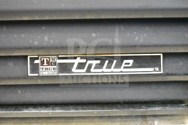 True GDM-49, 2-door cooler merchandiser, 115V, 1 Phase. "True" logo and manufacturer detail visible.
