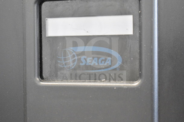 Seaga Commercial Floor Vending Machine, black finish, visible Seaga logo, durable steel construction, ideal for businesses.