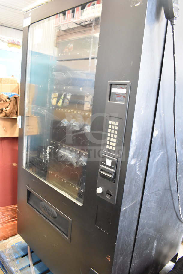 Seaga Commercial Floor Style Vending Machine, black, visible shelves, keypad, and coin slot, used condition.