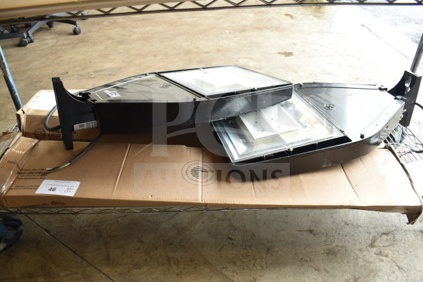 Four assorted items, including K5SM lights, in used condition on a metal rack. Includes cardboard packaging.