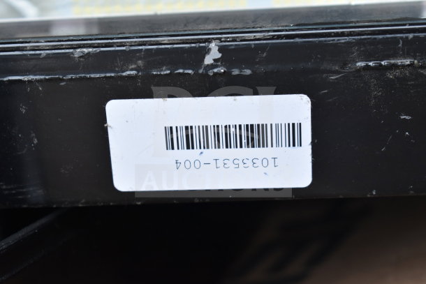 Barcode label on a black surface with slight wear, marked "103351-004." Part of a lot including K5SM lights and metal.