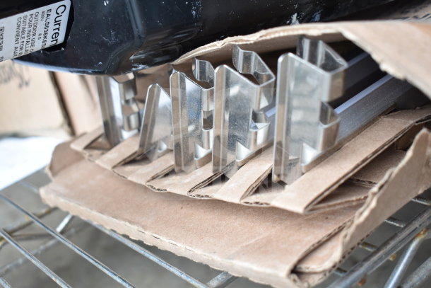 Metal brackets and K5SM lights on cardboard, condition suggests new or light use. Marked for outdoor use.