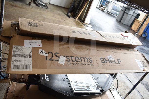 Three boxes of i2Systems advanced LED lighting, marked for auction. Includes retail display lighting.