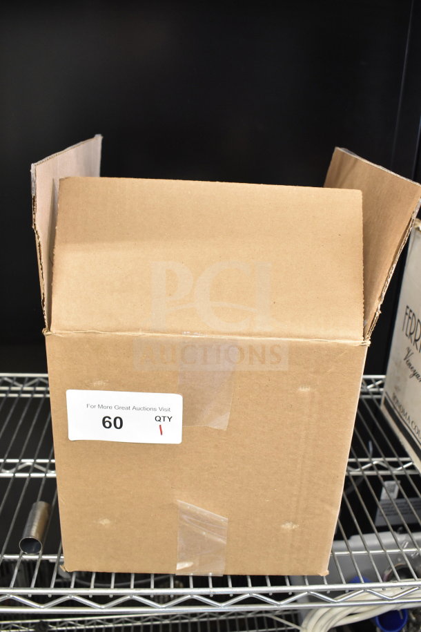 Cardboard box labeled "For More Great Auctions Visit" with item number 60, containing a brand new scratch and dent coffee machine brew basket.