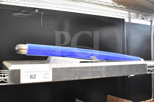 Four various items including metal panels, and a cylindrical blue-wrapped item on a shelf. Condition and labels visible.