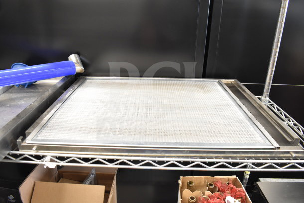 Metal panels on wire rack, featuring fine mesh and sleek frame. Includes additional items; all in good condition.