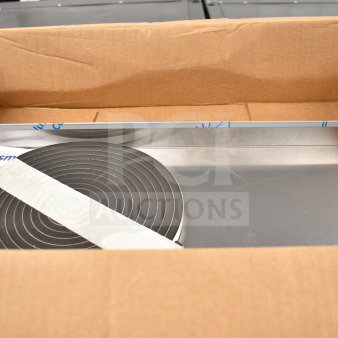 Cardboard box containing Scotsman ice machine part, instructions, and a metal piece; condition appears new.