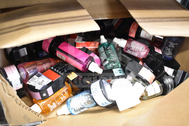 Box of assorted body and hair mists in various bottles. Assorted brands, colorful packaging, new condition.