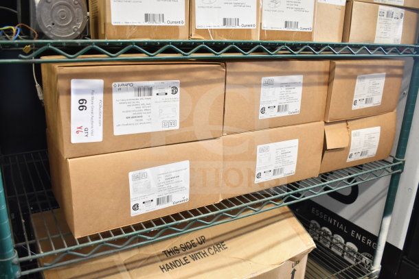 Boxes of DualLite EVHC6IDP-WM LED Emergency Lights, new condition, labels show model details, on metal shelf.