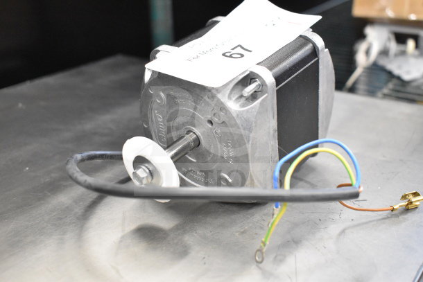 EBM Papst M4Q045-EF01-E5 motor, 230V, visible wiring, metal casing, good condition, auction tag attached.