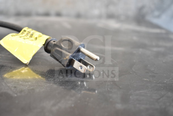 Power plug for IDW GCG-10-F2334B Reach In Cooler Merchandiser. 110-120 Volts, 1 Phase, with a yellow tag attached.