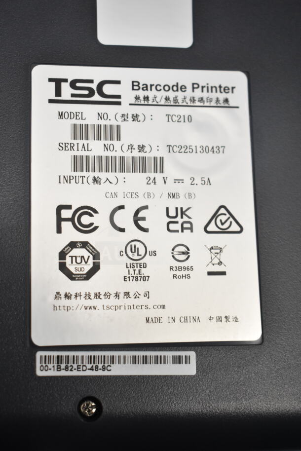 TSC TC210 Thermal Transfer Label Printer with model and serial number labels, showing compliance and input details.