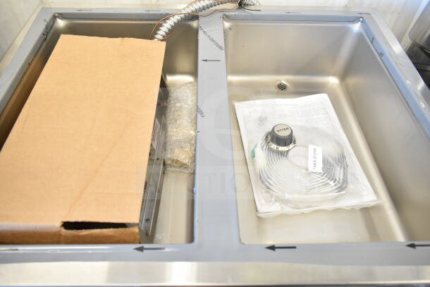 Brand new Wells MOD200TDM two-compartment hot food well with accessories, thermostatic control, and drain manifolds.