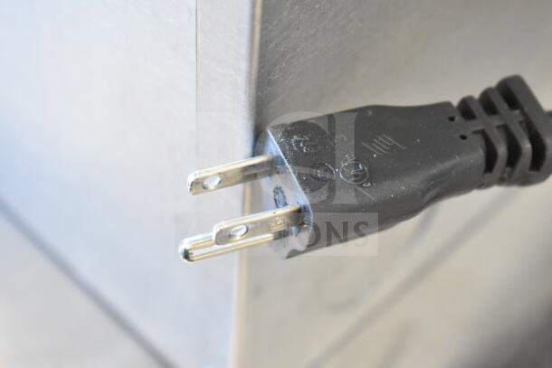 Plug detail of a Tre Spade BIG-80 Electric Tomato Mill, Model MOD200TDM, 120 Volts, 1 Phase, showing plug prongs and markings.