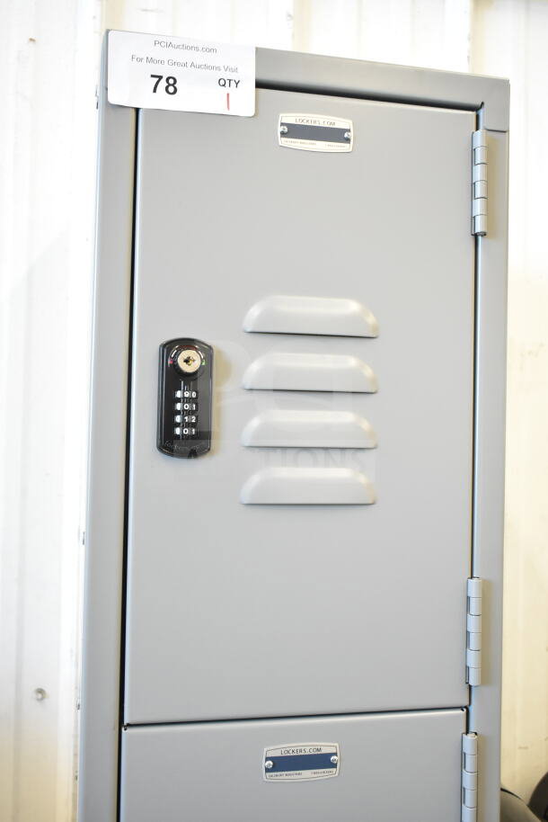 Brand new gray metal locker, four-tier, 6 ft high, 15 in deep, slight scratches and dents, combination lock, labeled.