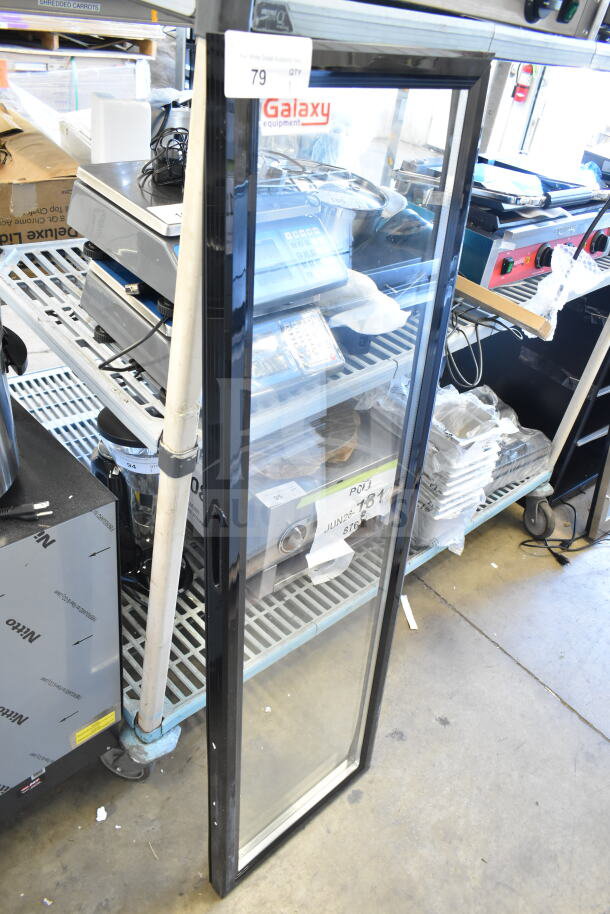 Alt text: Brand new Galaxy replacement merchandiser door with minor scratches, clear glass, black frame, and visible label.