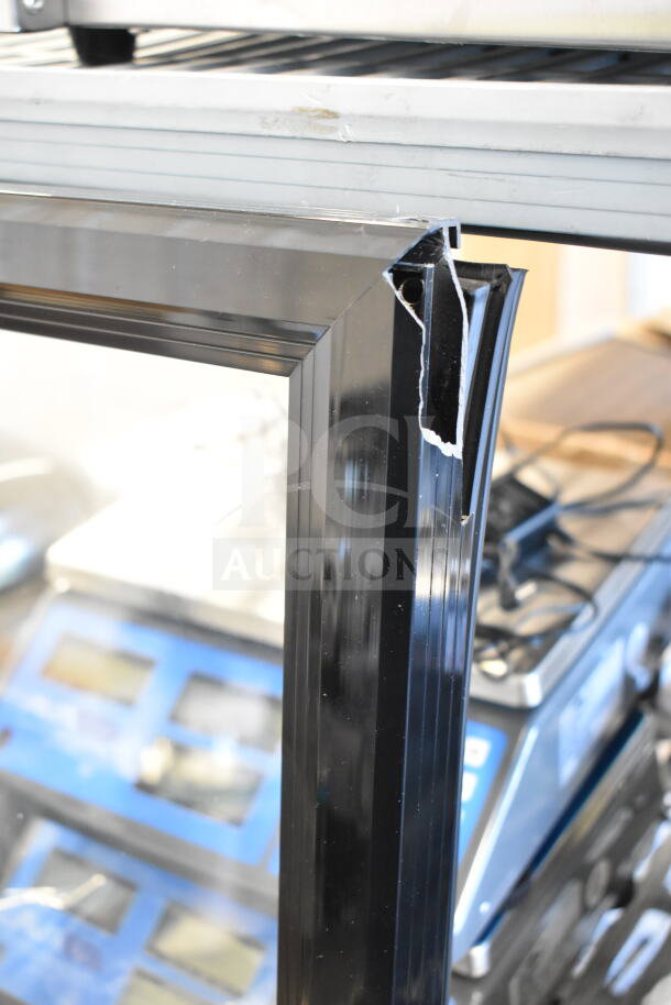 Brand new Galaxy merchandiser door with visible corner dents. Scratch and dent condition.