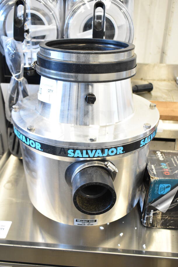BRAND NEW Salvajor 200 Commercial Garbage Disposer, 2 hp, 208V, 1 Phase. Minor scratches and dents visible. Model label shown.