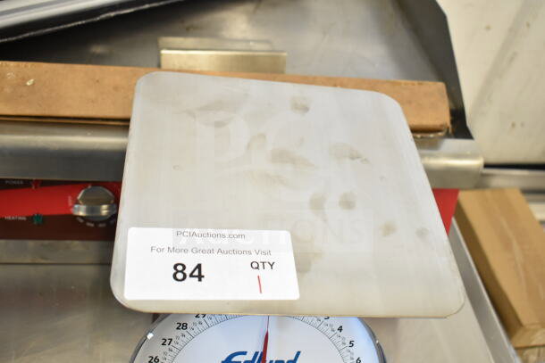 BRAND NEW Edlund HD-2 portion scale, 32 oz capacity, 8.5"x8.5" platform, visible tag marked "84," scratch and dent condition.