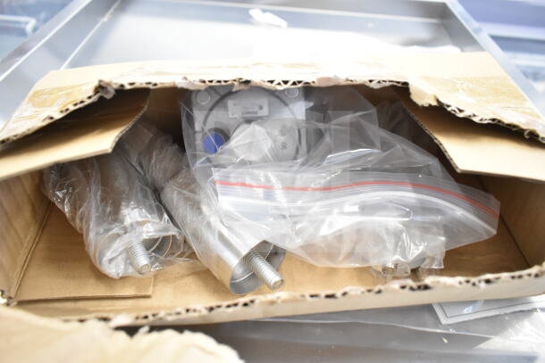 Box contents of a BRAND NEW SCRATCH AND DENT Cooking Performance Group GT-CPG-48-NL griddle, packed in plastic.