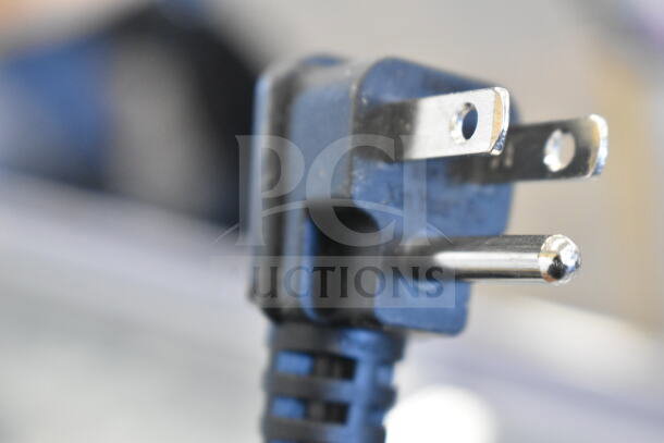 Close-up view of a standard three-prong power plug, part of the Avantco 360ADC12N ice cream dipping cabinet, 115 Volts.