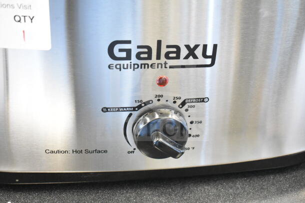 Brand new Galaxy 177ACR22SS 22 Qt. roaster oven with scratch and dent, temperature dial, and "Caution: Hot Surface" label.