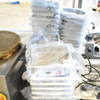 Stack of 48 new stainless steel drop-in bins, Choice brand, 1/6 size, 4" and 6" deep, anti-jam feature, in packaging.