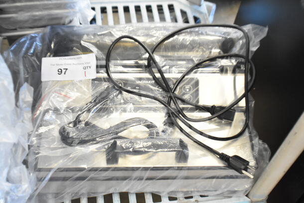 Brand new VacPak-It 186VME12SS vacuum packaging machine with 12" seal bar. Includes visible power cables. Model and auction tag shown.