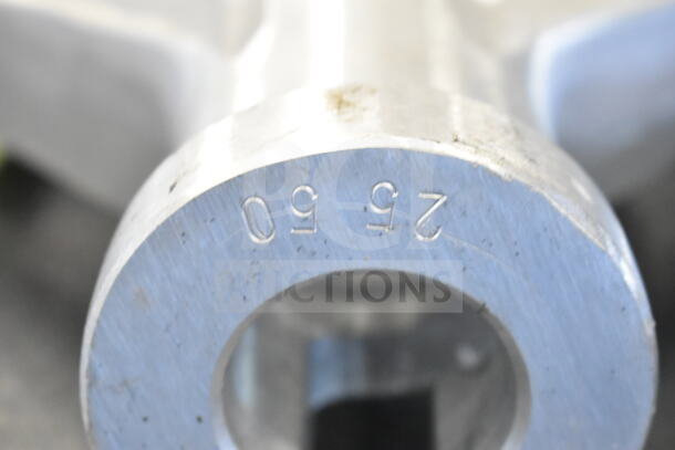 Close-up of a metal piece with engraved numbers "26 90," possibly part of a Vigor stock pot or Vollrath flat beater.