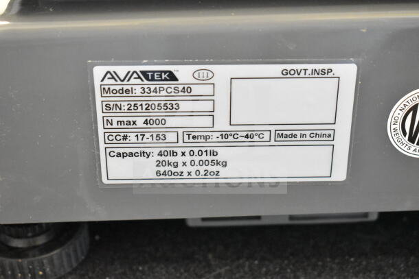 Alt text: AvaTek 334PCS40 digital price computing scale label showing model, S/N, capacity 40lb x 0.01lb, made in China.