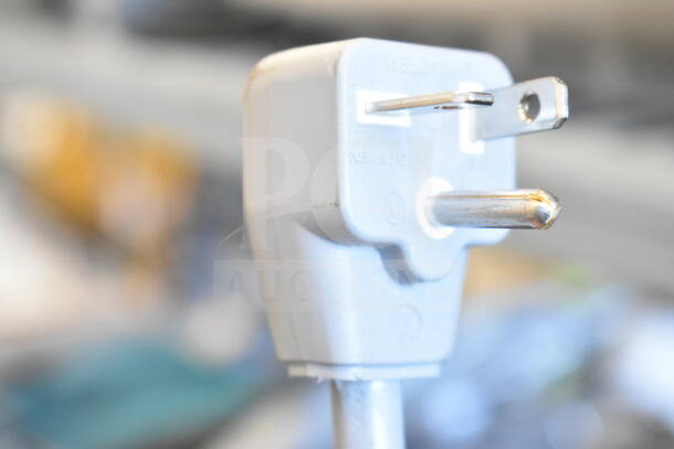 Close-up of a power plug for the Solwave 180MW2100TH microwave, showing standard three-prong design.