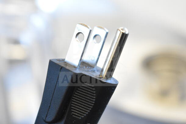 Close-up of a power plug for the AvaMix 928BX2100E commercial blender, highlighting outlet compatibility.