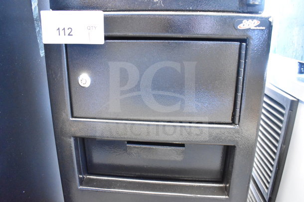 "Brand NEW 360 Office Furniture black steel depository safe, 14x14x27 1/4”, with electronic keypad lock, top locker. Slight scratch and dent, tag 112 visible."