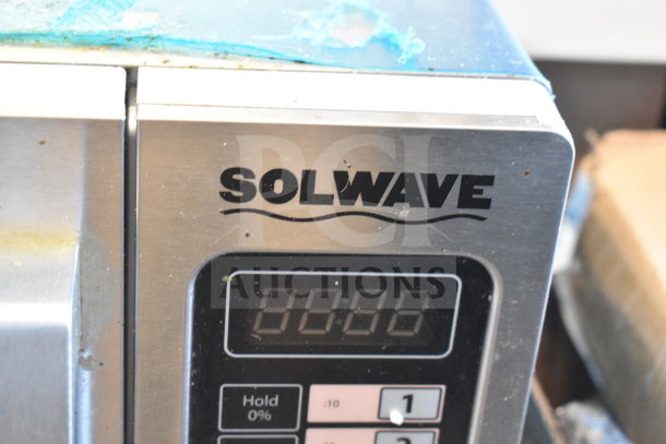 BRAND NEW Solwave 180MW1000SS commercial microwave with push button controls, labeled 120 volts, shows some scratches.