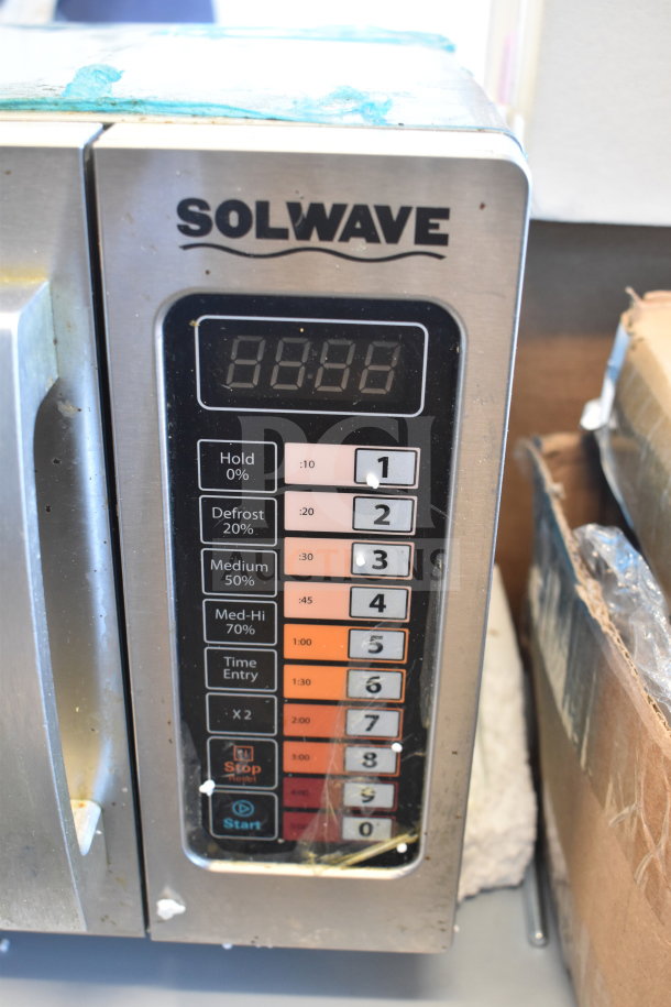 Brand new 2024 Solwave 180MW1000SS commercial microwave with push button controls, 120 Volts, slight scratches visible.